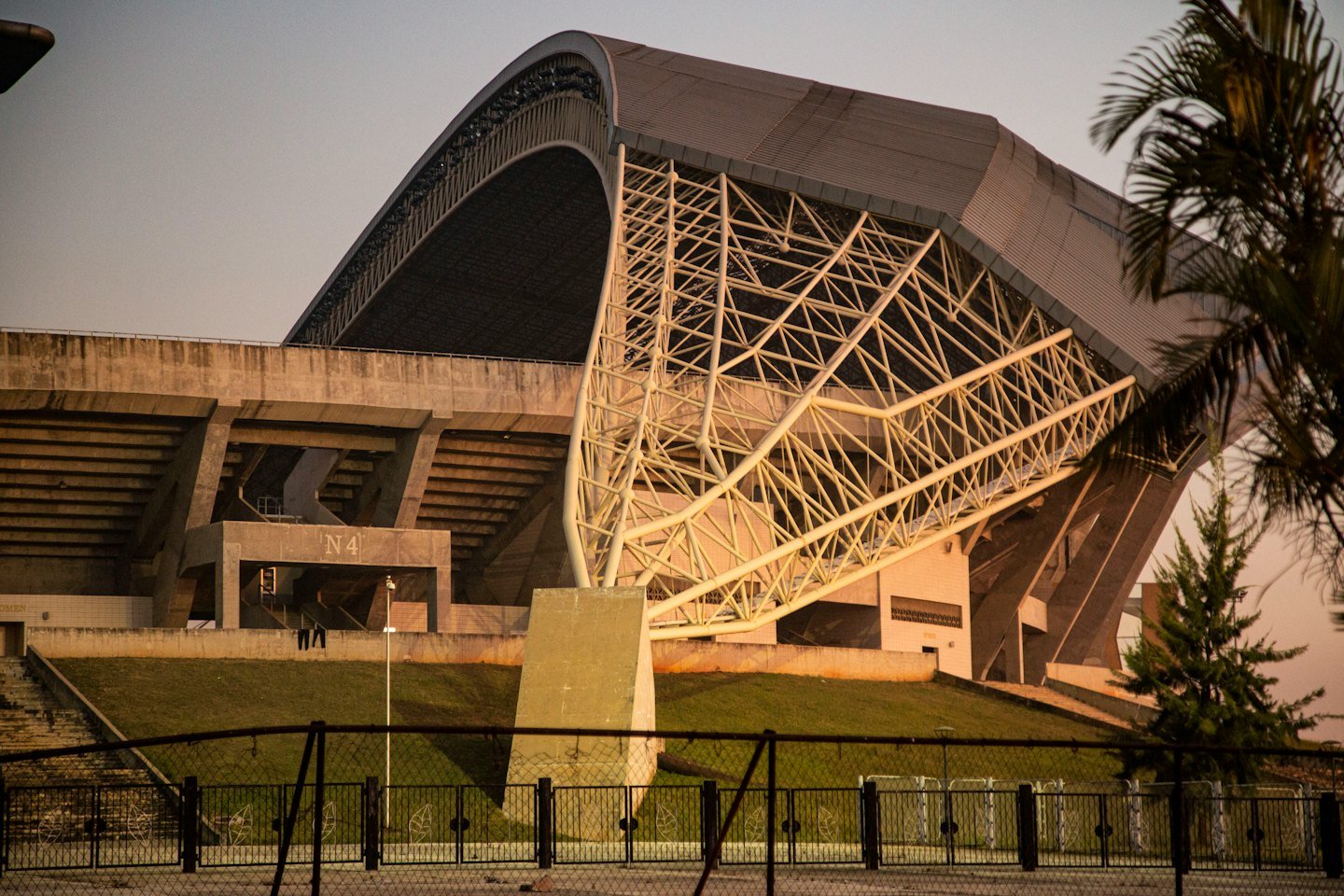 Modern stadium with an arched roof and concrete seating.